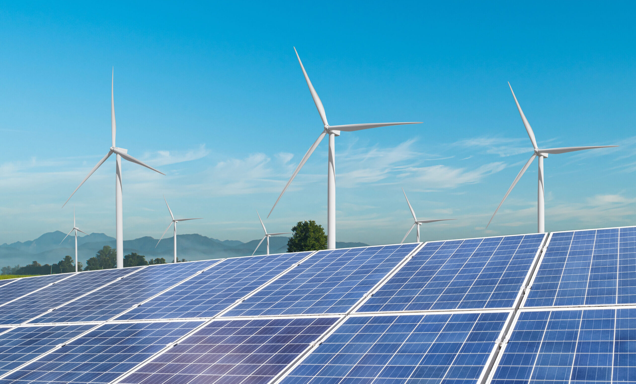 Solar,Panels,With,Wind,Turbines,Generating,Electricity,Over,Blue,Sky